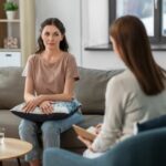 woman being counselled in office by another woman