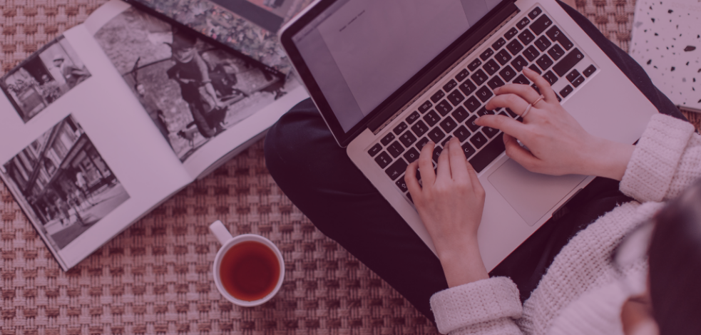 Faded image of hands on computer